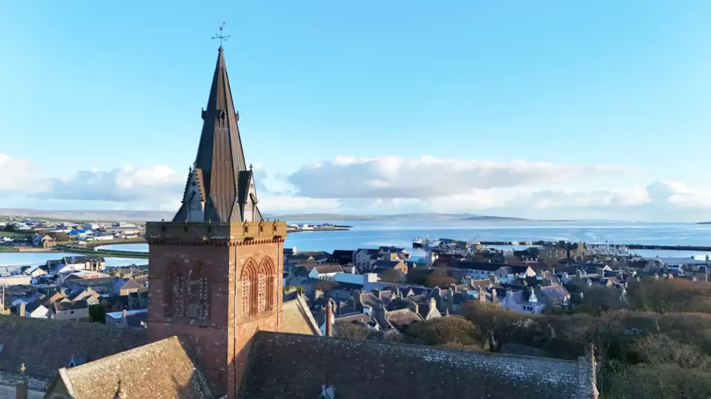 The cathedral tower and spire against a blue sky