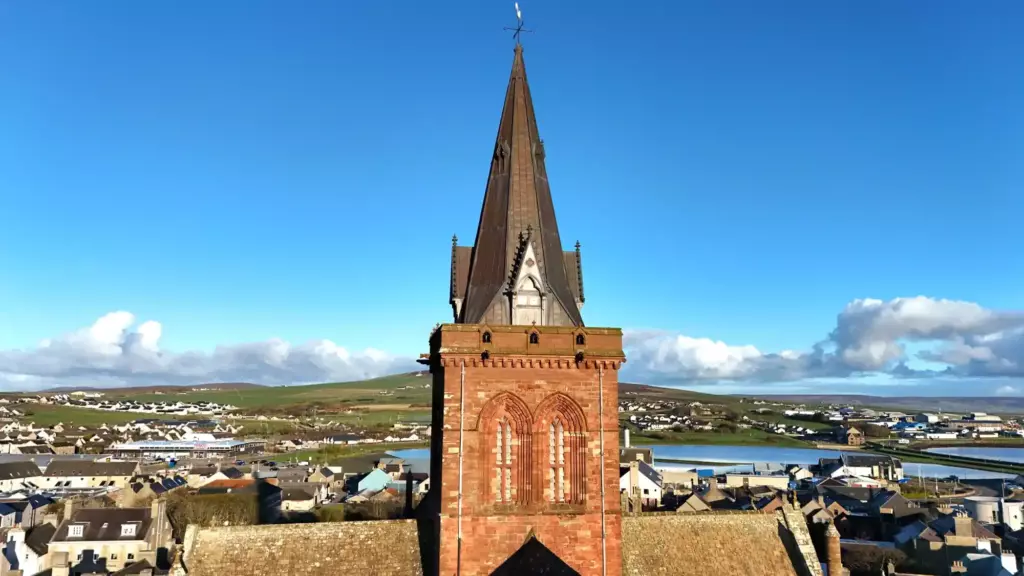 The cathedral tower and spire, with Kirkwall and the sea behind